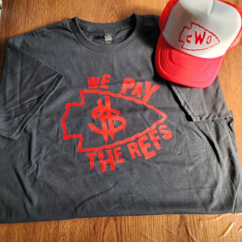 Red "We Pay The Refs" on Black Shirt